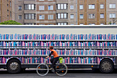 Germany, Berlin, Mitte, Heinrich Heine Strasse, bookmobile in street, biker