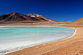 Chile, San Pedro de Atacama, Laguna Tuyajto, colored mountain in the back, person near the lake