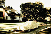 Car Covered With Tarpaulin in Front of Suburban Home, Venice, California, USA