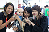 European baby boy with three Thai women smiling, Chiang Mai, Thailand, Asia