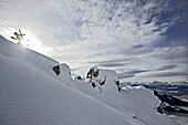 Snowboarder ascending in deep snow, Chandolin, Anniviers, Valais, Switzerland