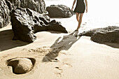 Young woman at beach near heart shaped, Fuerteventura, Spain