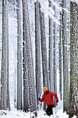 Man jogging through winter scenery, Irsee, Bavaria, Germany