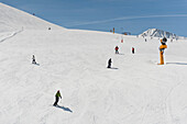 Skiers on a ski slope in the sunlight, Serfaus, Tyrol, Austria, Europe