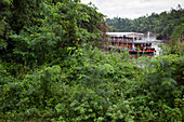Lush jungle setting for river cruise ship RV River Kwai (Cruise Asia Ltd.) on River Kwai Noi, near Kanchanaburi, Thailand