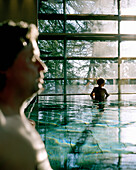 Couple bathing in indoor pool, Vigiljoch, Lana, Trentino-Alto Adige/Suedtirol, Italy