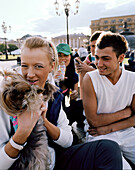 Teenage friends with little dog at Manege square, Moscow, Russia, Europe