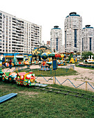 Amusement park amidst high rise buildings at metro station Bratislavskaya, southeastern Moscow, Russia