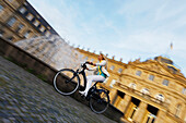 Frau fährt E-Bike, Radtour, Schlossplatz, Neues Schloss, Stuttgart, Baden-Württemberg, Deutschland