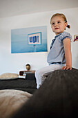 Little girl sitting on the couch, 3 years