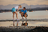 Couple wearing sports clothing at lake Starnberg, Bavaria, Germany