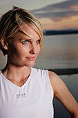 Woman wearing singlet at lake shore, Lake Starnberg, Bavaria, Germany