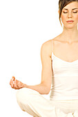 Young woman sitting, yoga attitude, shut eyes, close up