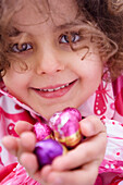 Little girl holding Easter eggs