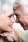 Smiling senior couple face to face, close-up