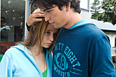 Teenage boy consoling teenage girl