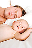 Portrait father and baby sleeping, indoors