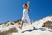 Little girl running on the beach, outdoors