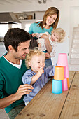Couple and 2 children playing in kitchen