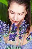 Young woman holding lavender sprigs