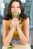 Woman smelling chives