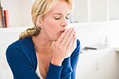 Close-up of a woman coughing