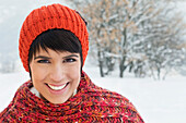 Young woman in winter clothes smiling at camera