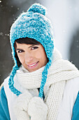 Young woman in winter clothes smiling at camera