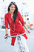Portrait of a beautiful young woman cycling