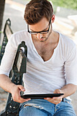 Man using a digital tablet, Paris, Ile-de-France, France