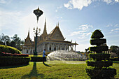 Garden with gardener pouring the grass, Royal Palace, Phnom Penh, Cambodia
