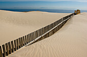 Fence cutting through sand on beach, Punta Paloma, La Costa De La Luz, Spain