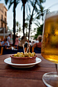 Beer & olives in cafe in palm filled square, Palma, Majorca, Spain