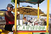 A woman selling Caipirinha from a mobile cart at a beach , Brazil