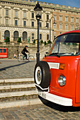 Cyclist passing Royal Palace located on Stadsholmen (city island) in Gamla Stan (old town), Stockholm, Sweden