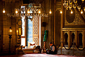 Man reading the Qaran or Koran in the New Mosque, Istanbul Turkey