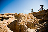 Spain, Navarre, two men on mountain bike in Bardenas Reales desert