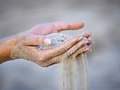 Woman's hands with sand