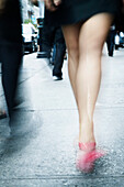 Woman's legs walking in the street, heel shoes