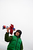 Boy playing with model airplane