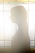 Woman Silhouette Against Stained Glass