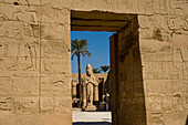 Looking through doorway of Temple of Ramses III to Colossus of Ramses II, precinct of Amun, Karnak Temple, Luxor, Egypt