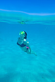 Woman snorkelling off Giftun Island on Red Sea coast near Hurghada, Egypt