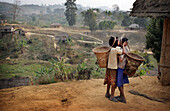 Two girls from the Bru tribe kissing, Tripura, North East States, India.  The Bru Tribe is also known as the Reang Tribe.