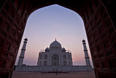 The Taj Mahal at dusk as seen through arch, Agra, Uttar Pradesh, India