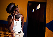 Rasta leaning against bar, Porus, Jamaica