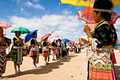 Hmong girls in traditional costume throwing tennis balls at a courting ceremony at the New Year festival, Phonsavan, Laos