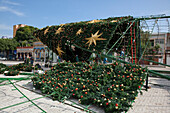 Workers set up Christmas tree and decorations on plaza opposite Theatro Amazonas Manaus opera house, Manaus, Amazonas, Brazil, South America