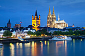 View over the Rhine river to church Groß St. Martin and cathedral in the evening, Cologne, North Rhine-Westphalia, Germany, Europe