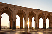 Looking through archways of the Hassan II mosque at dusk, Casablanca, Morocco.